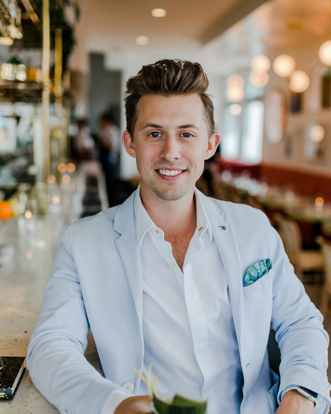 A confident young professional in a light blazer