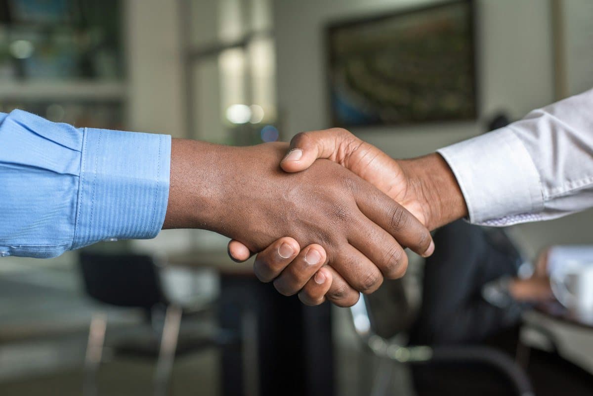 An employer and a verified candidate shaking hands